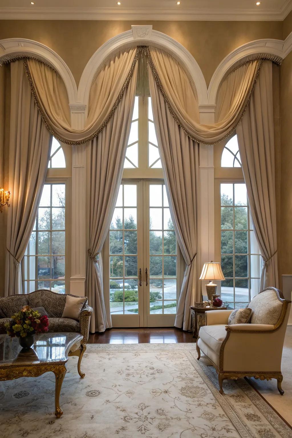 Sophisticated living room with drapery panels framing arched windows.