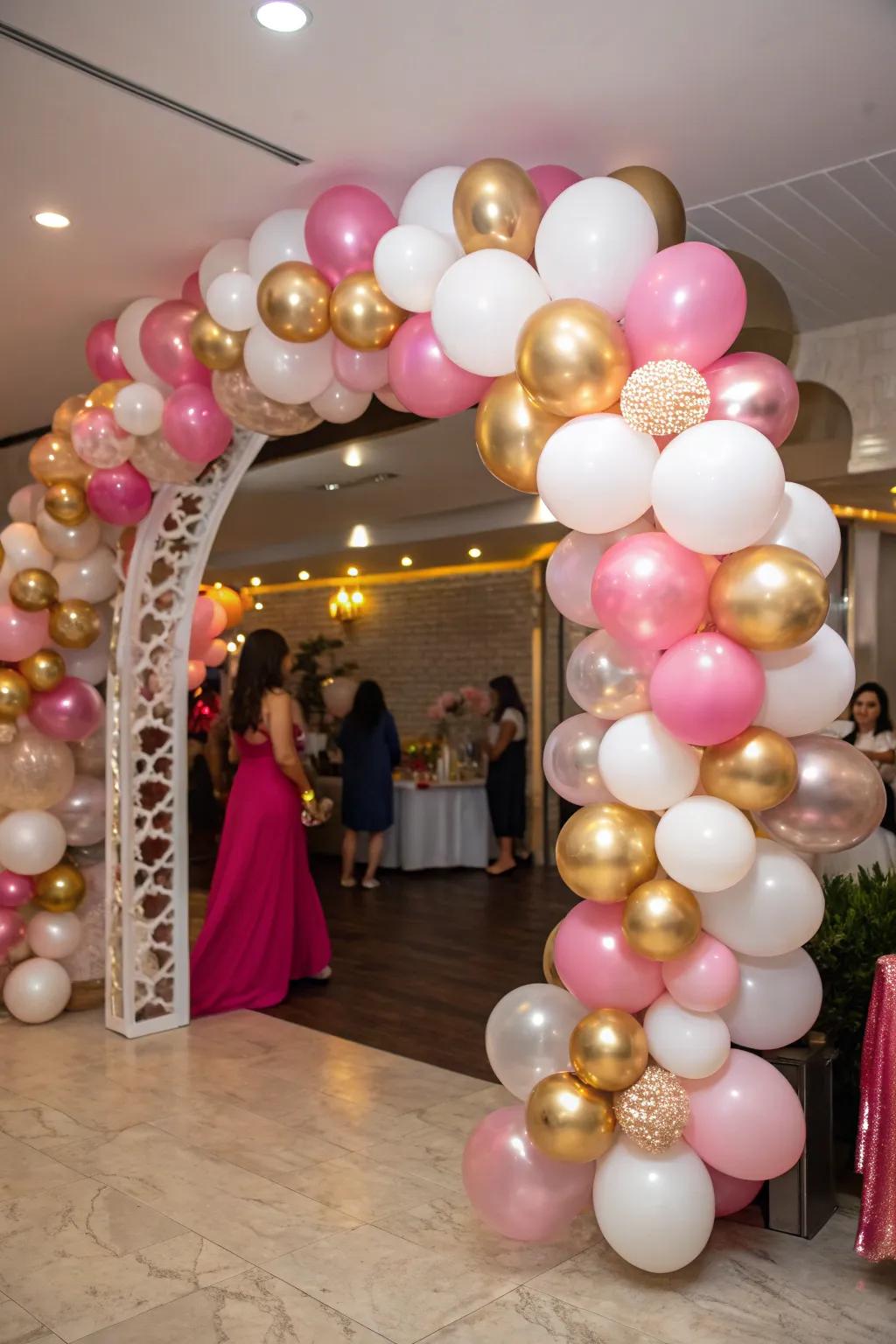 An eye-catching balloon arch featuring metallic rose, gold, and ivory.
