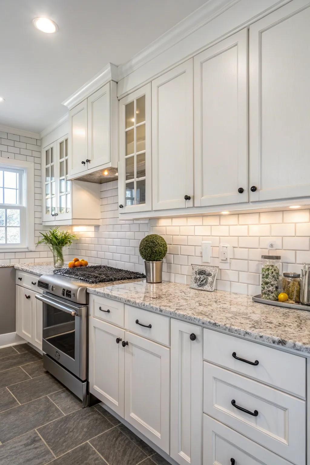 Traditional rectangular tiling as a backsplash perfectly enhances the white cabinetry and granite surfaces.