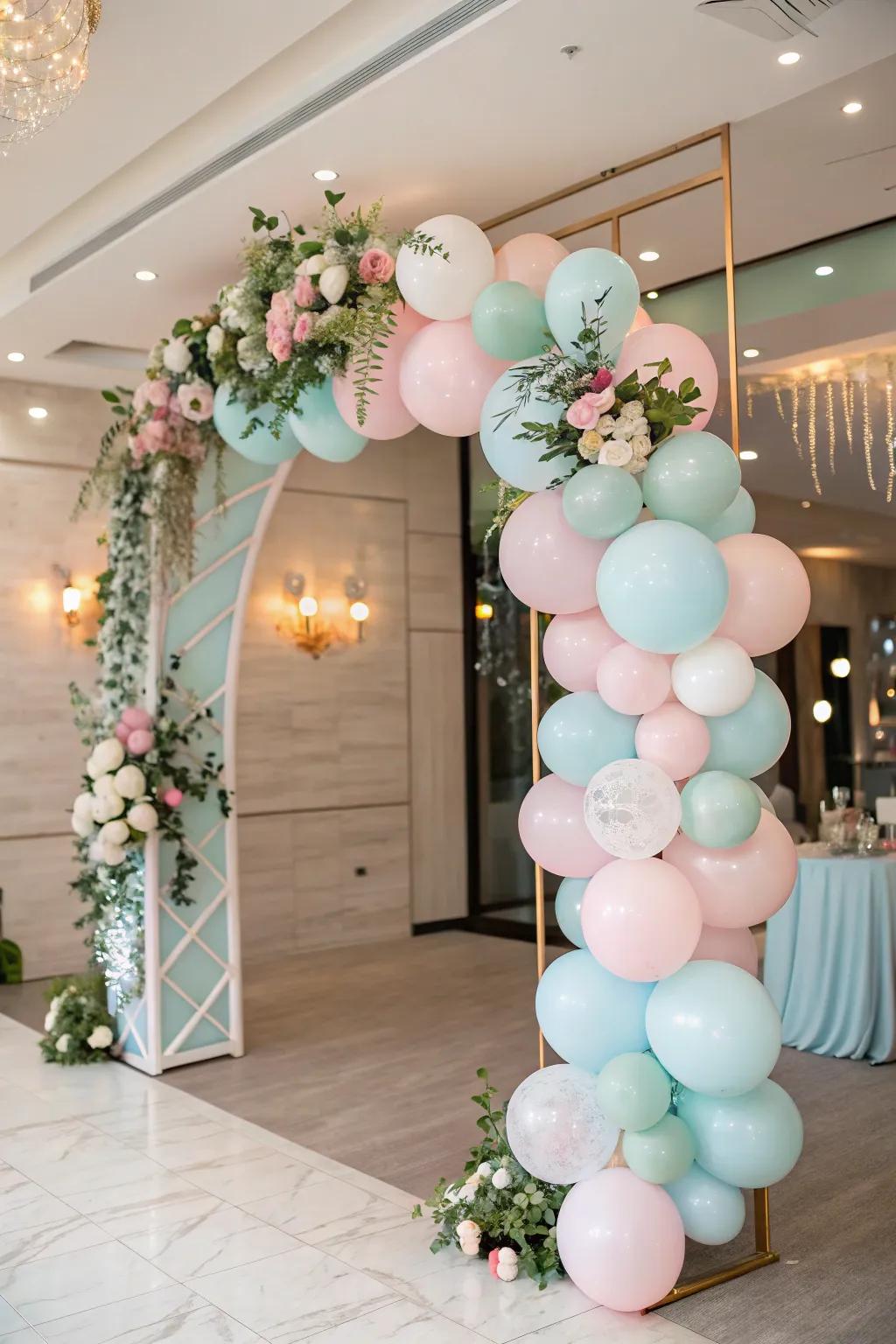 An elegant balloon gateway perfectly welcomes guests to a baby shower.
