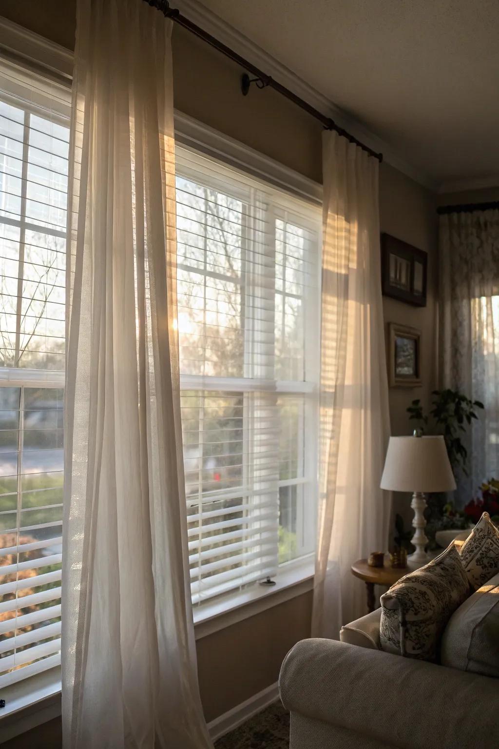 Sheer curtains layered over solid blinds create a refined and gentle atmosphere.