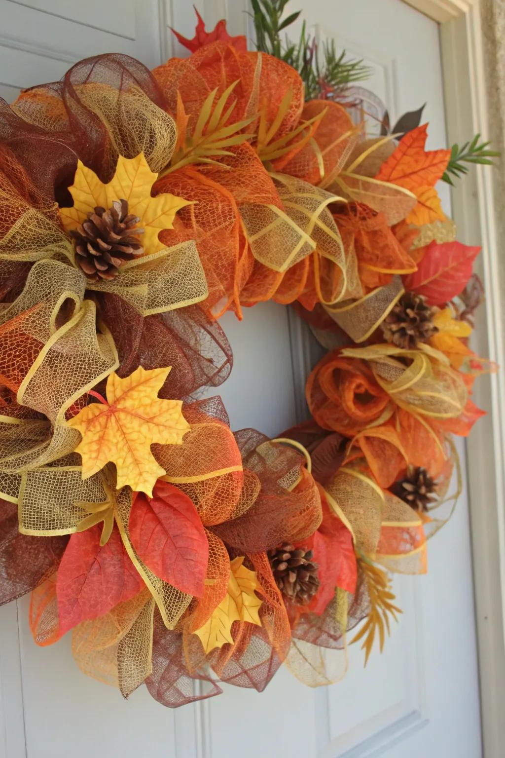 A classic autumn-colored wreath featuring deco mesh and fall foliage.