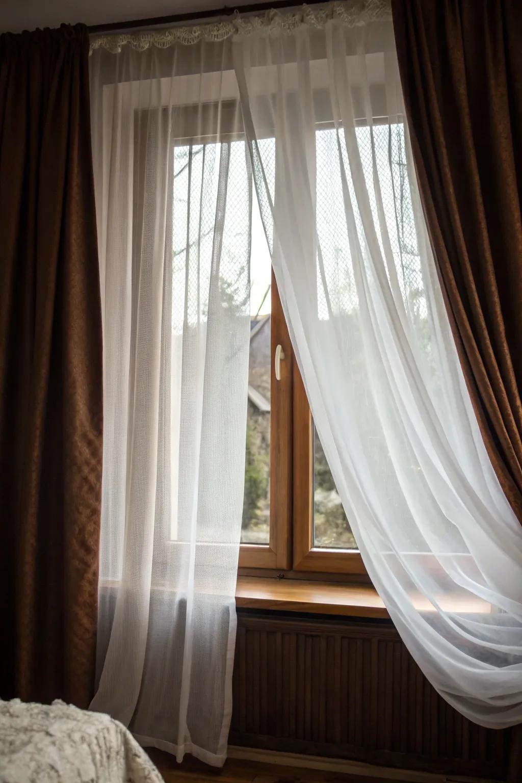 Layered sheers and darkening drapes create an intimate and cozy bedroom atmosphere.
