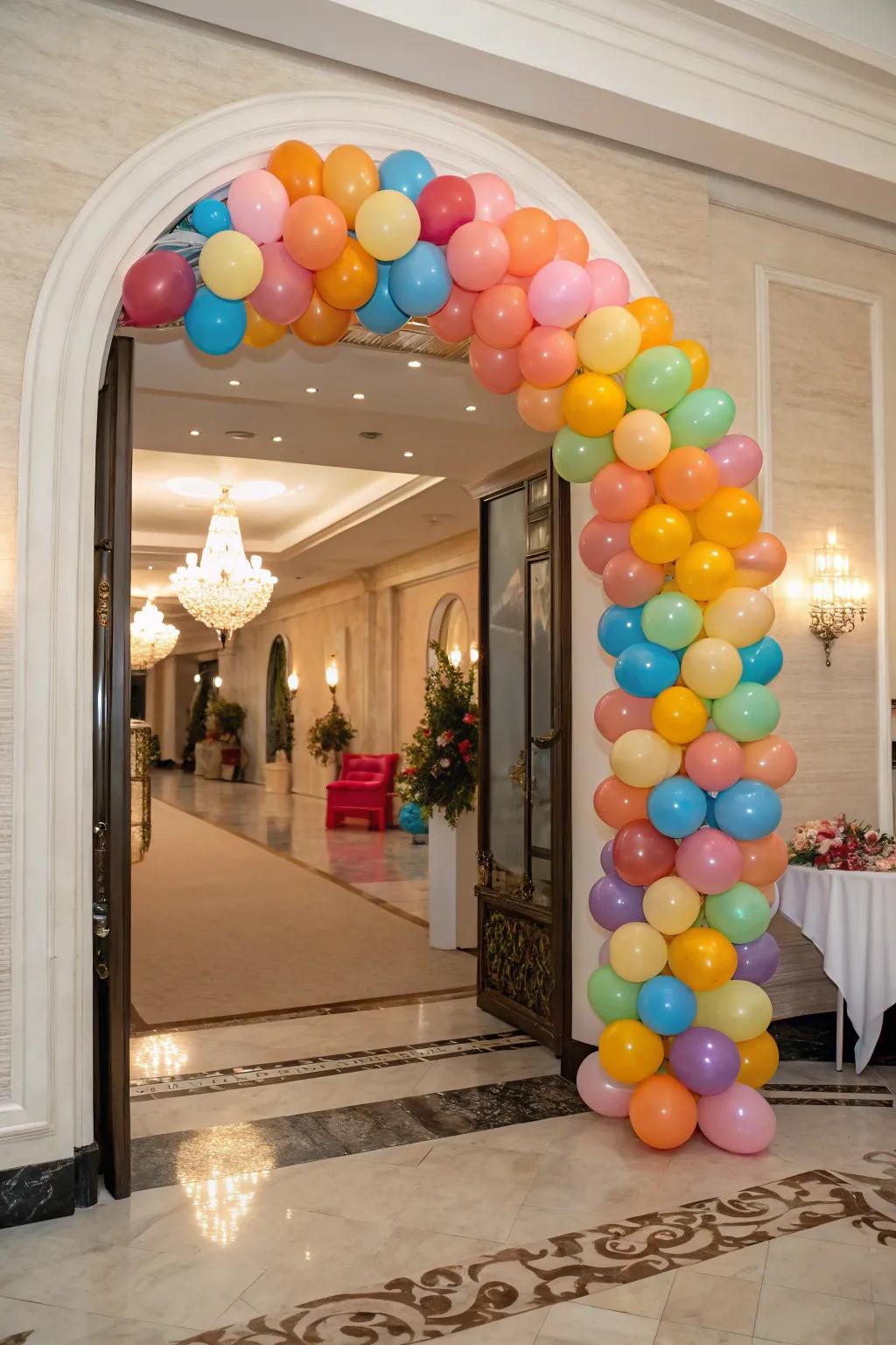A dynamic balloon arch graces an elegant doorway, employing a range of sizes and colors to produce a vibrant visual.