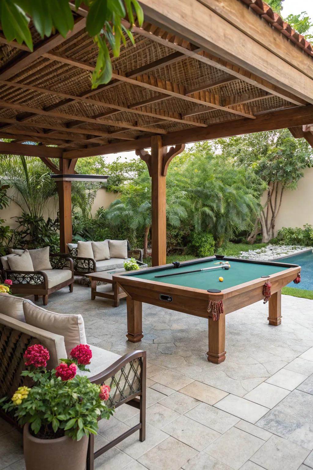 A cozy pool table area under a wooden canopy, complete with seating and garden plants.