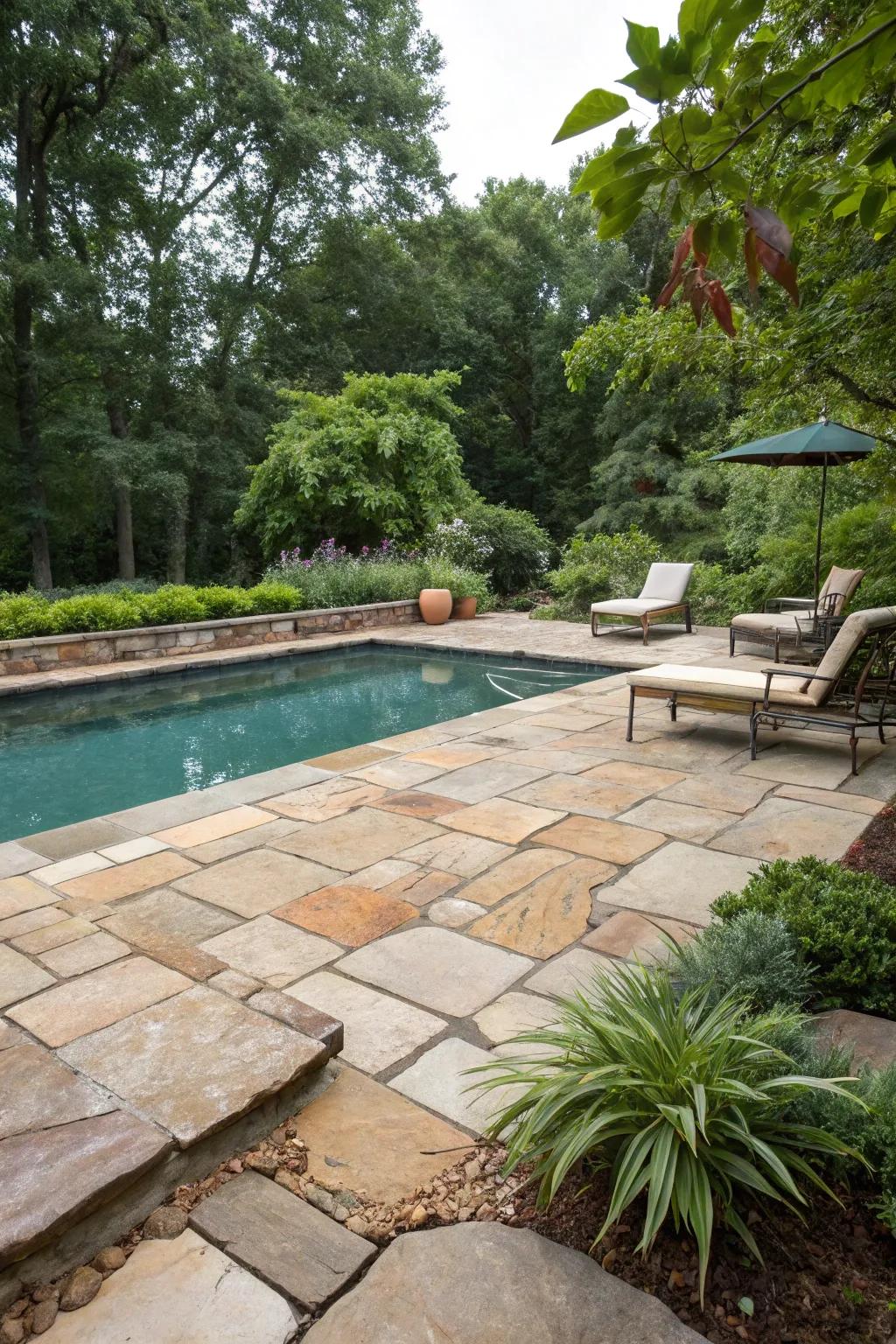 Natural stone pavers impart a timeless and organic elegance to this pool area.