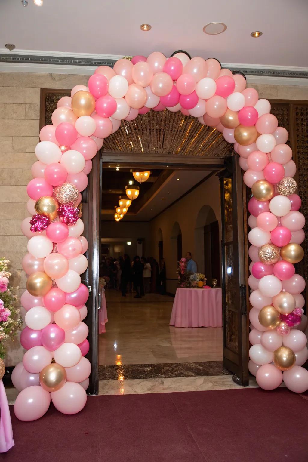 A pink balloon arch establishes a celebratory atmosphere from the outset.