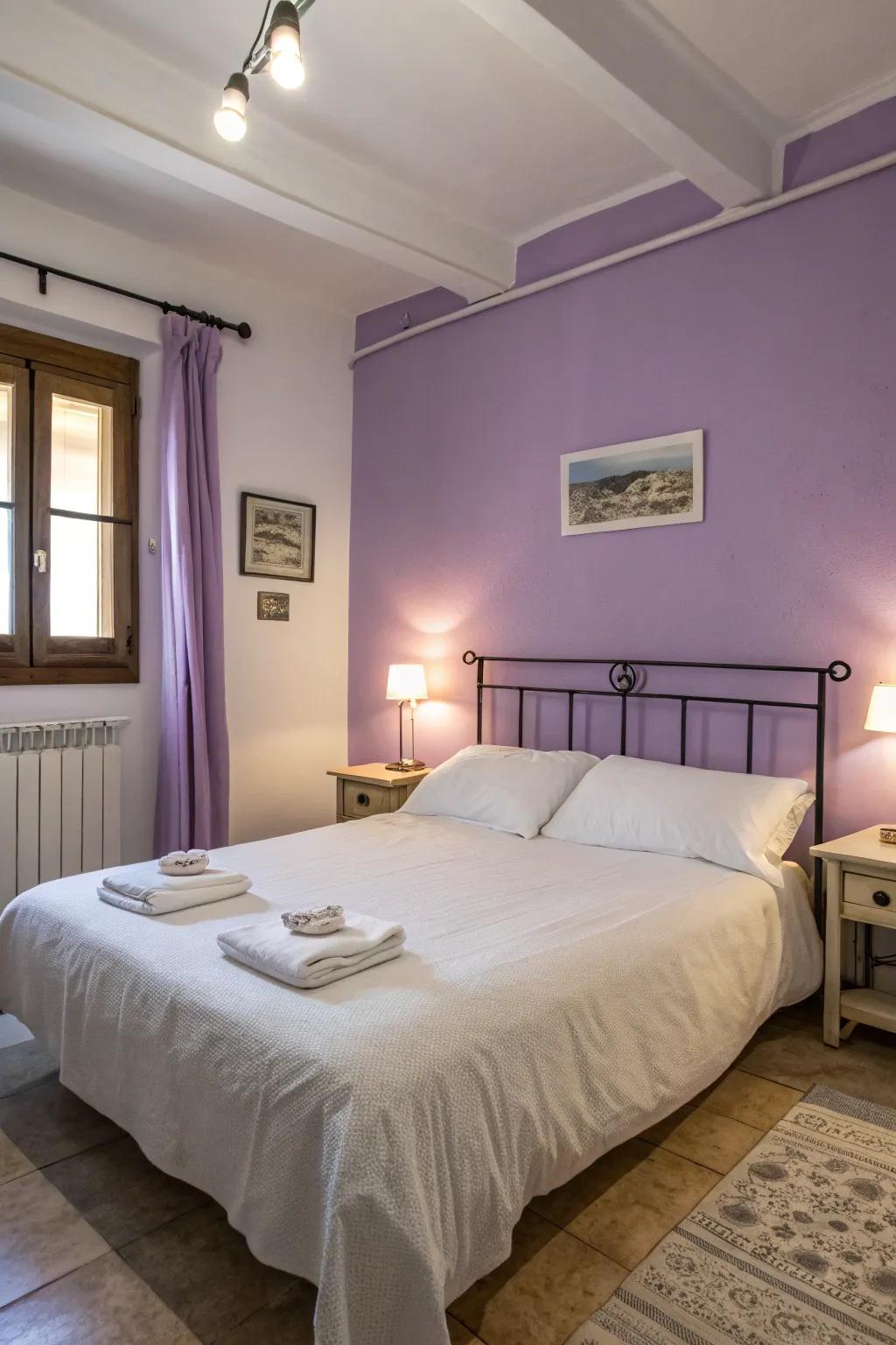 A peaceful bedroom featuring lavender walls and fresh white bedding.