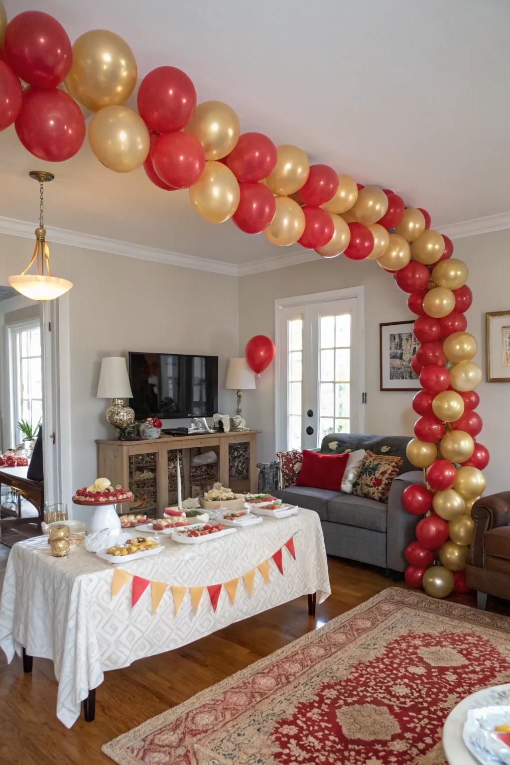 A dazzling red and gold balloon garland makes for a celebratory entrance.