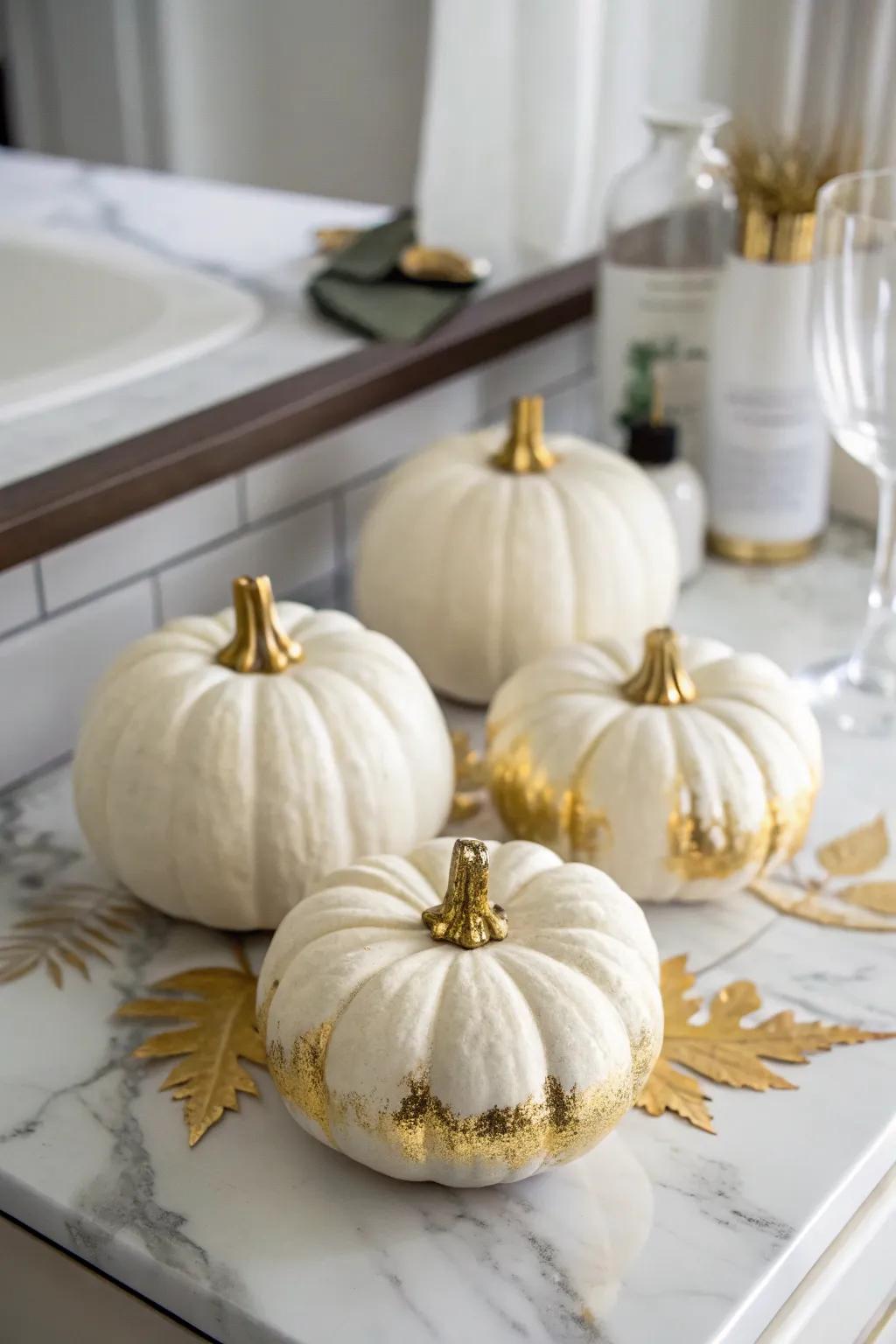 White pumpkins with gold accents for a luxurious touch.