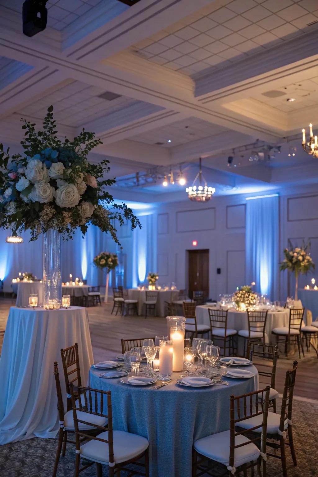 A reception space transformed by the soft glow of dusty blue lighting, setting a romantic mood.