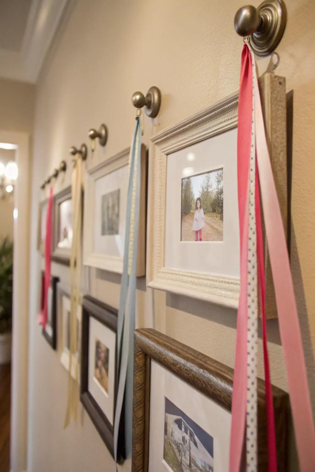 An interesting wall display featuring frames suspended from knobs with ribbons.