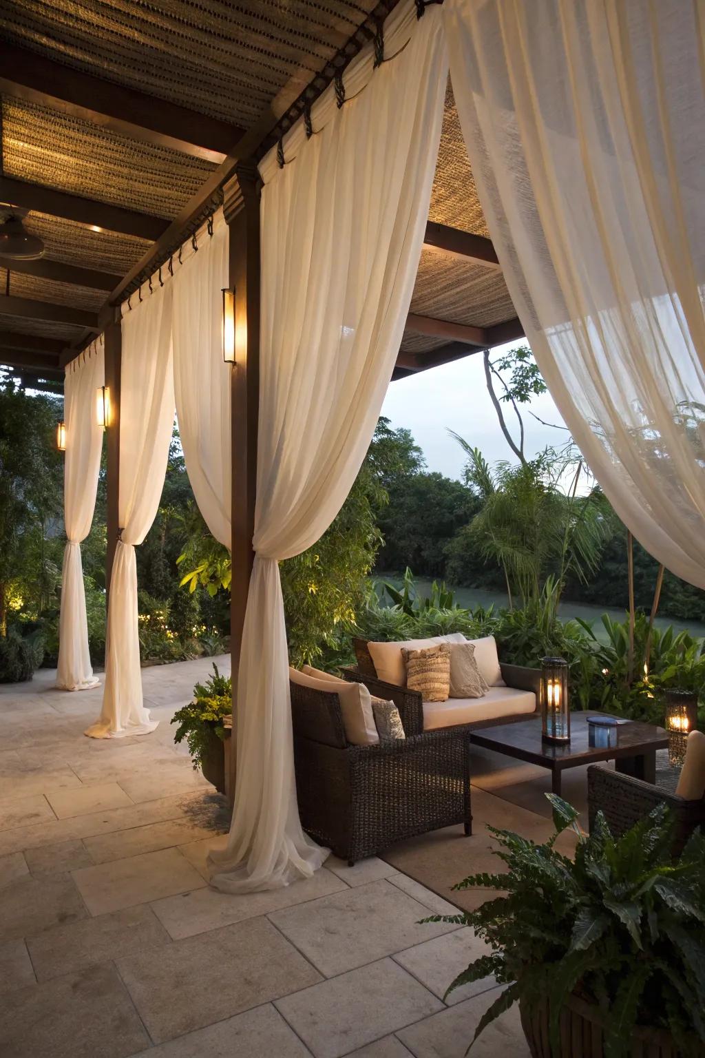 Elegant fabrics creating a cozy and private patio space.