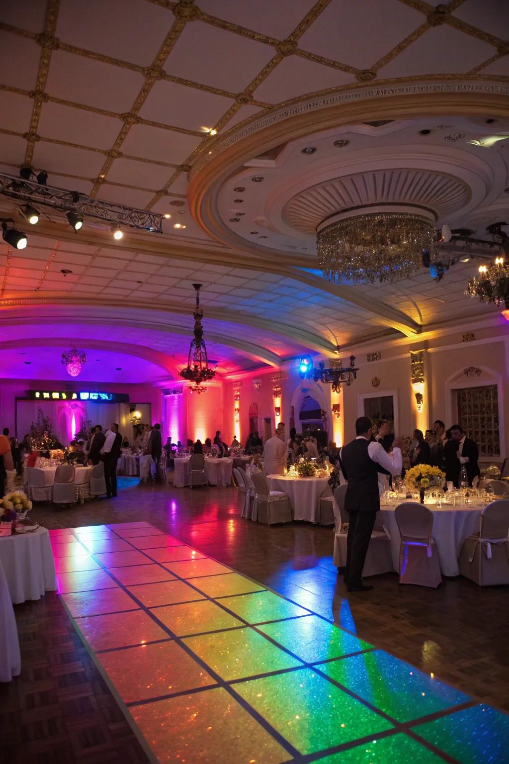 A wedding reception venue beautifully illuminated with rainbow lighting.