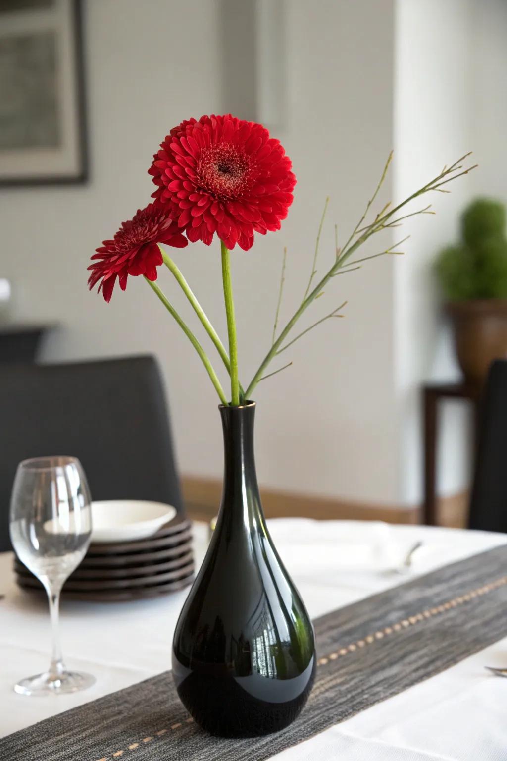 A single scarlet bloom in an ebony container for a minimalist and striking centerpiece.