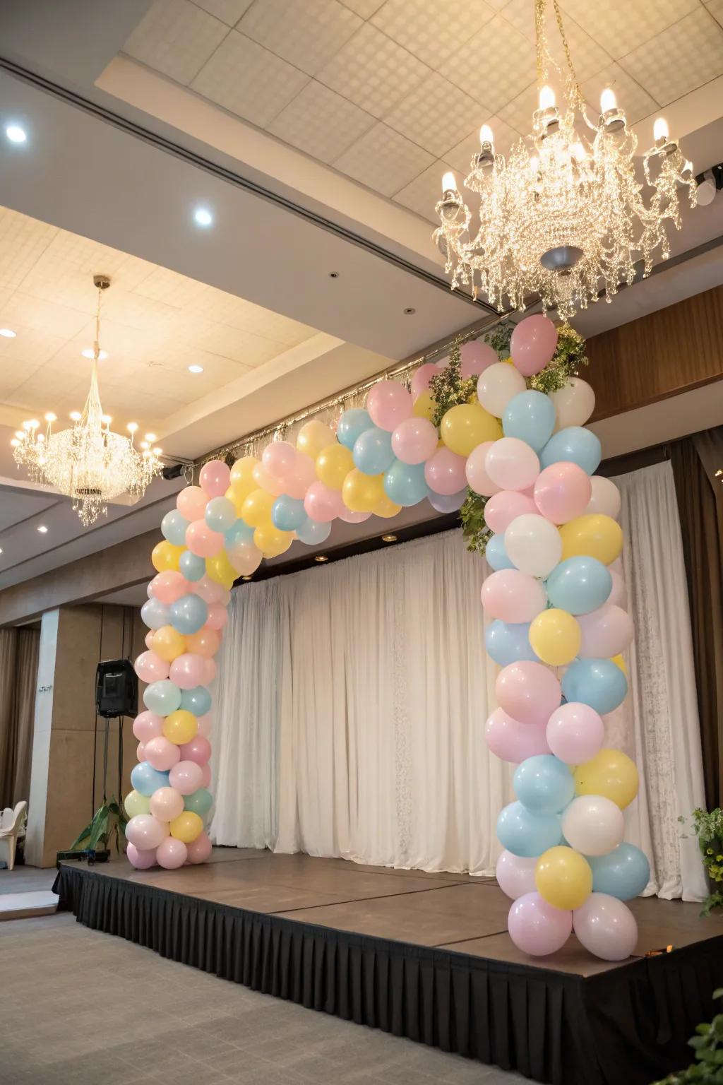 A whimsical balloon chandelier hanging above the stage.