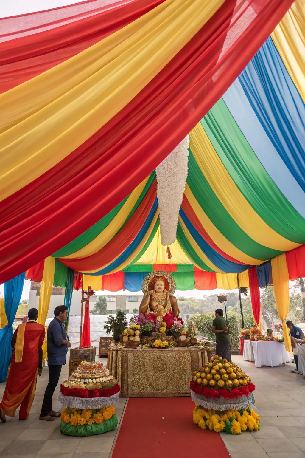 Dramatic and colorful fabrics creating a canopy over the Ganesh Chaturthi setup.