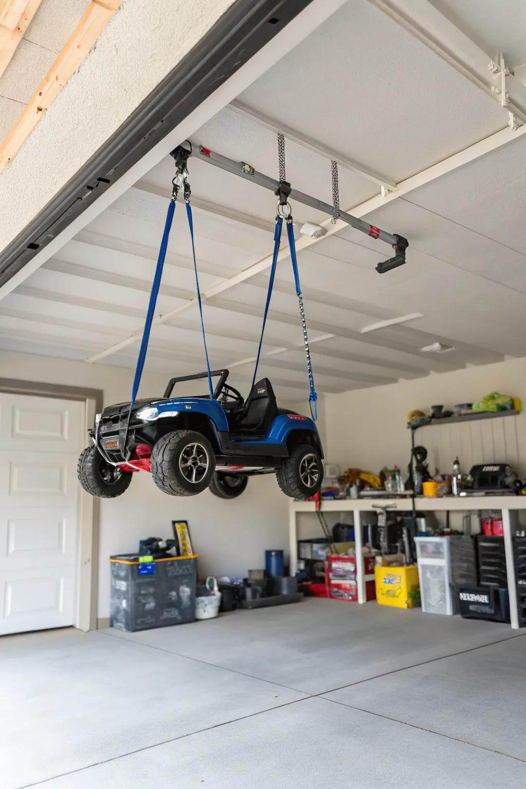 Hanging belts suspending electric ride-ons to clear floor space.