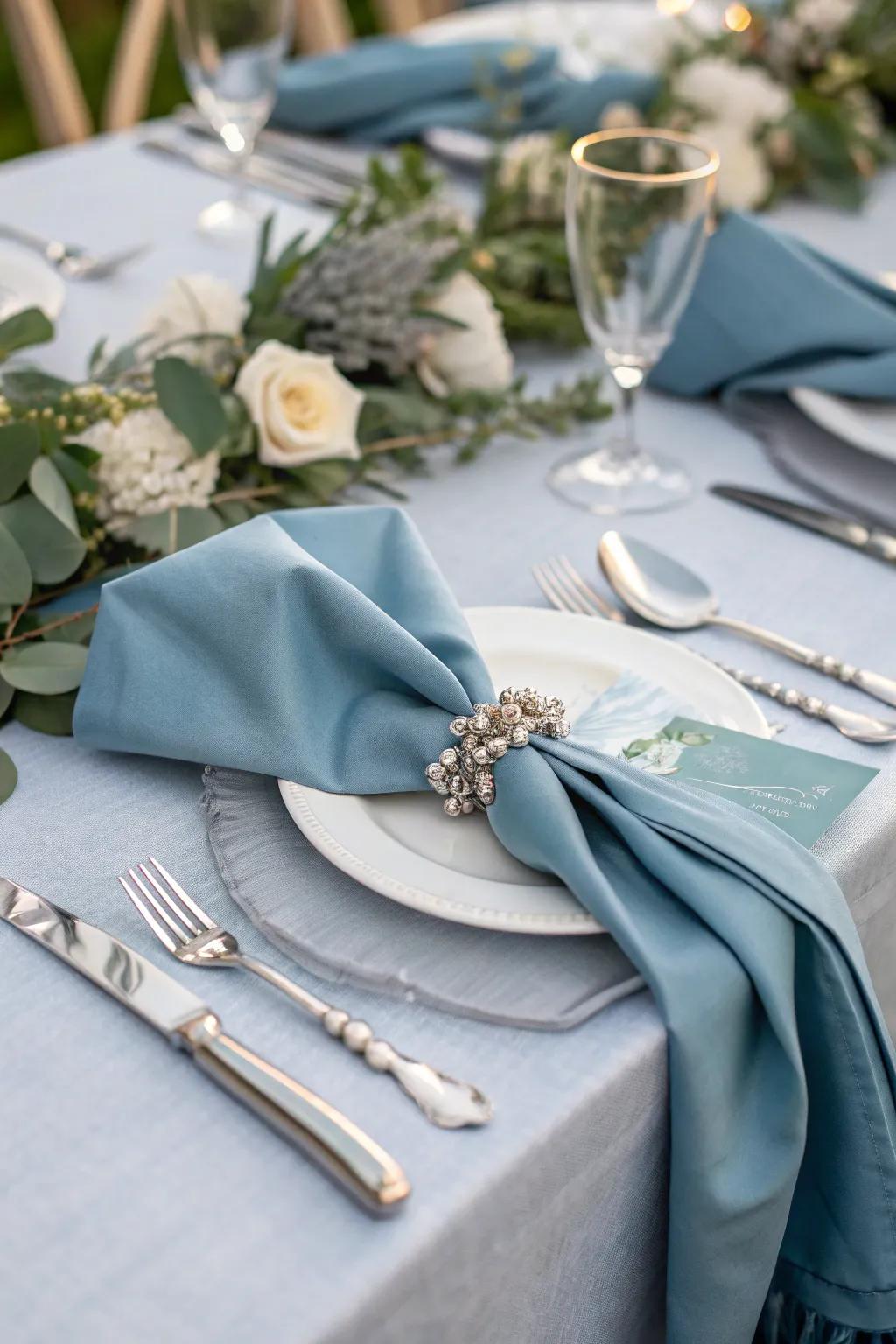 A refined table setting featuring dusty blue napkins that enhance the dining experience.