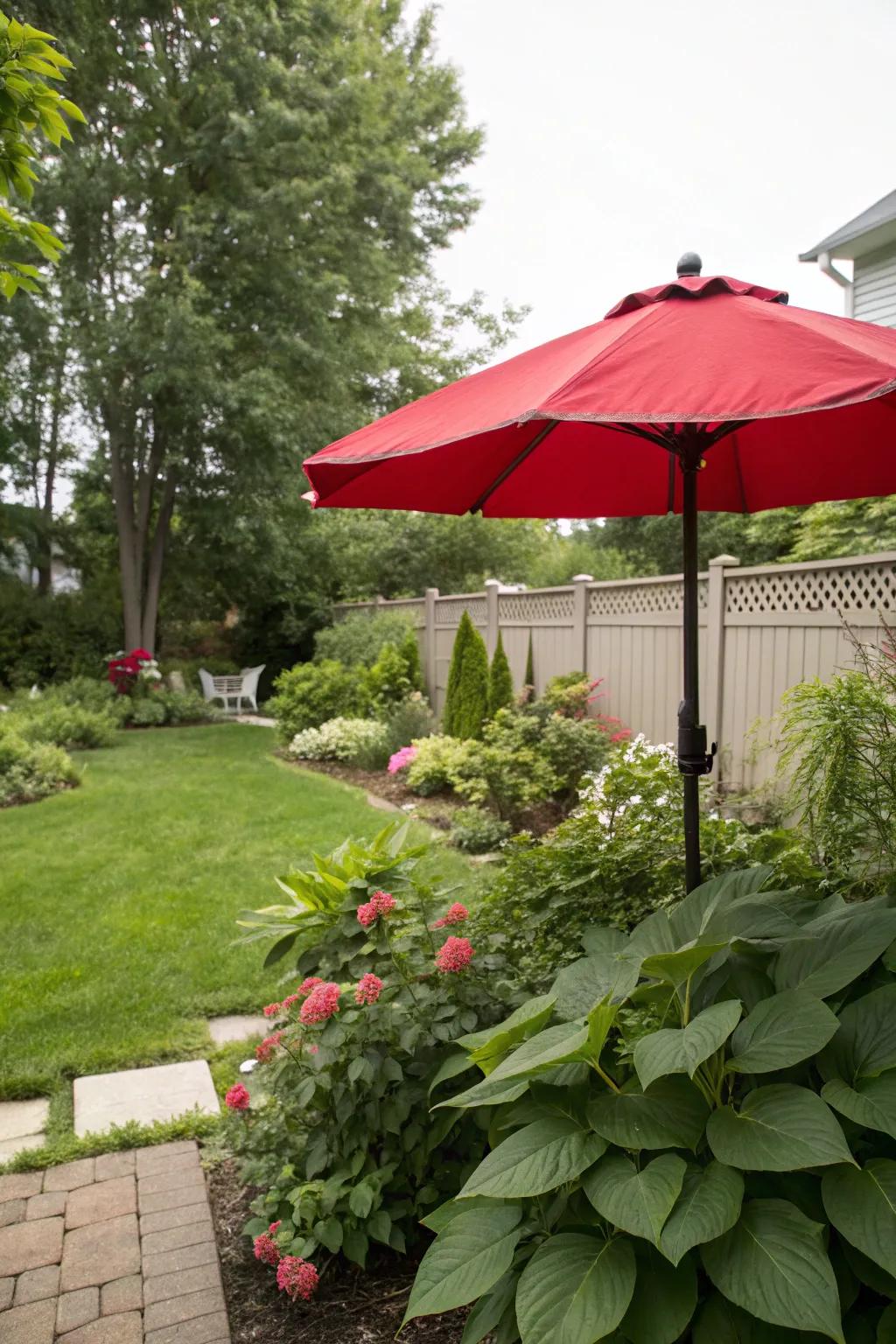 A backyard featuring a vibrant red umbrella for a pop of color.