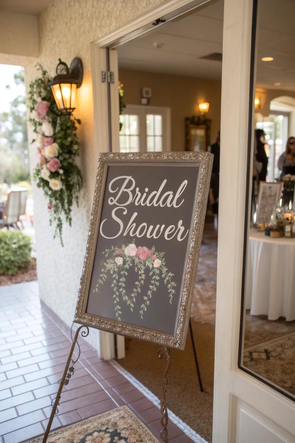 A glamorous reflective surface sign featuring writing incorporates sophistication to the bridal shower doorway.