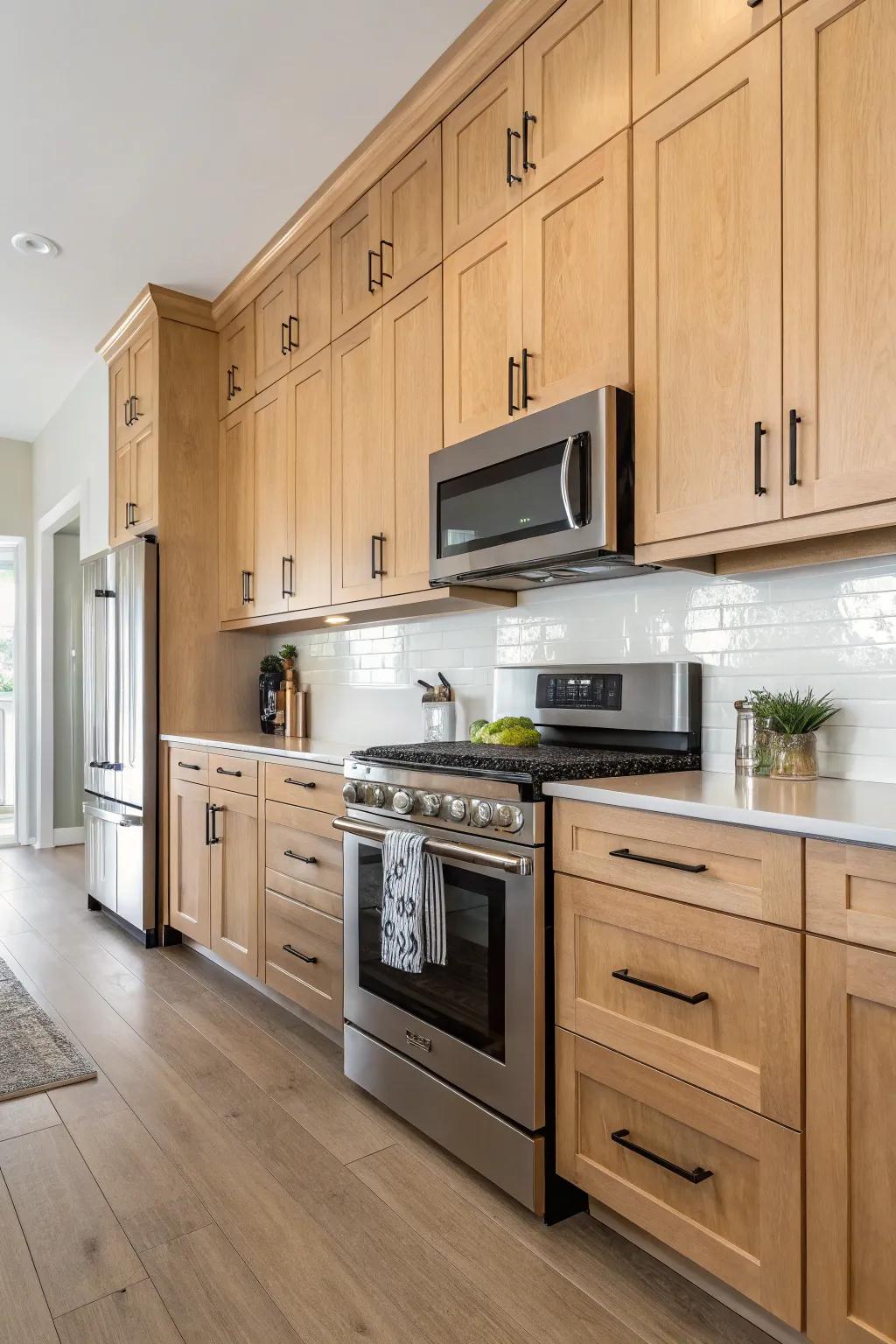 Streamlined accents introduce a modern touch to pale walnut cabinets.