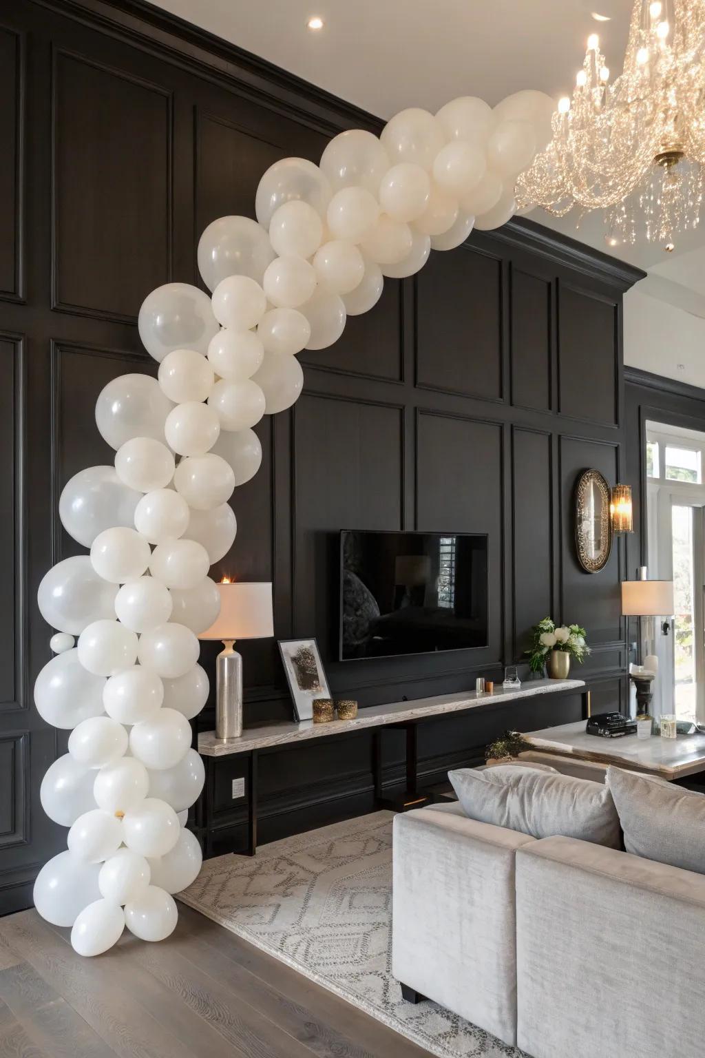 Stylish white balloon garland establishes a classy setting.