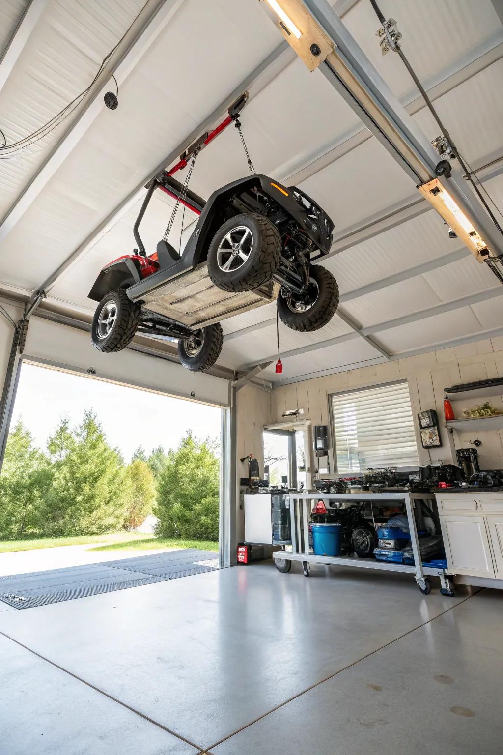 Overhead hoist system lifting an electric ride-on to maximize space.