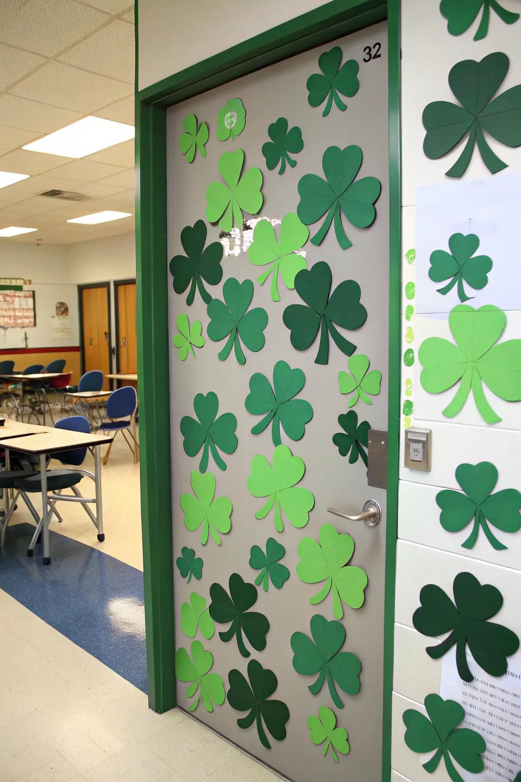 A classroom door decorated with shamrocks in shades of green, ideal for St. Patrick's Day.