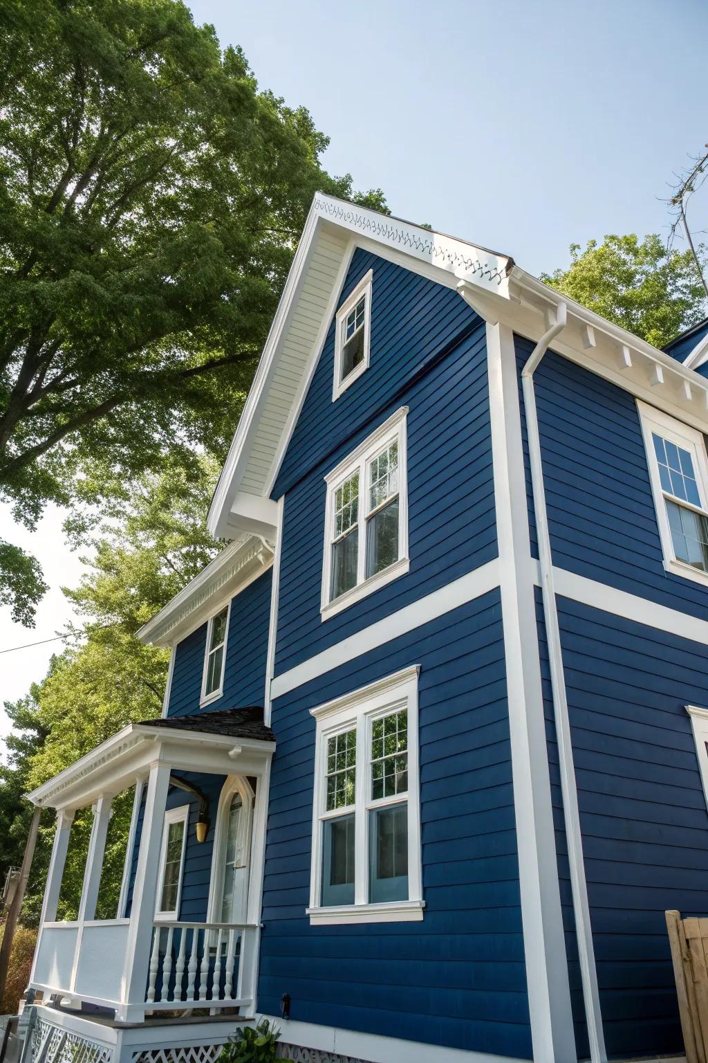 A house showcasing bold dark blue siding paired with contrasting white trim.