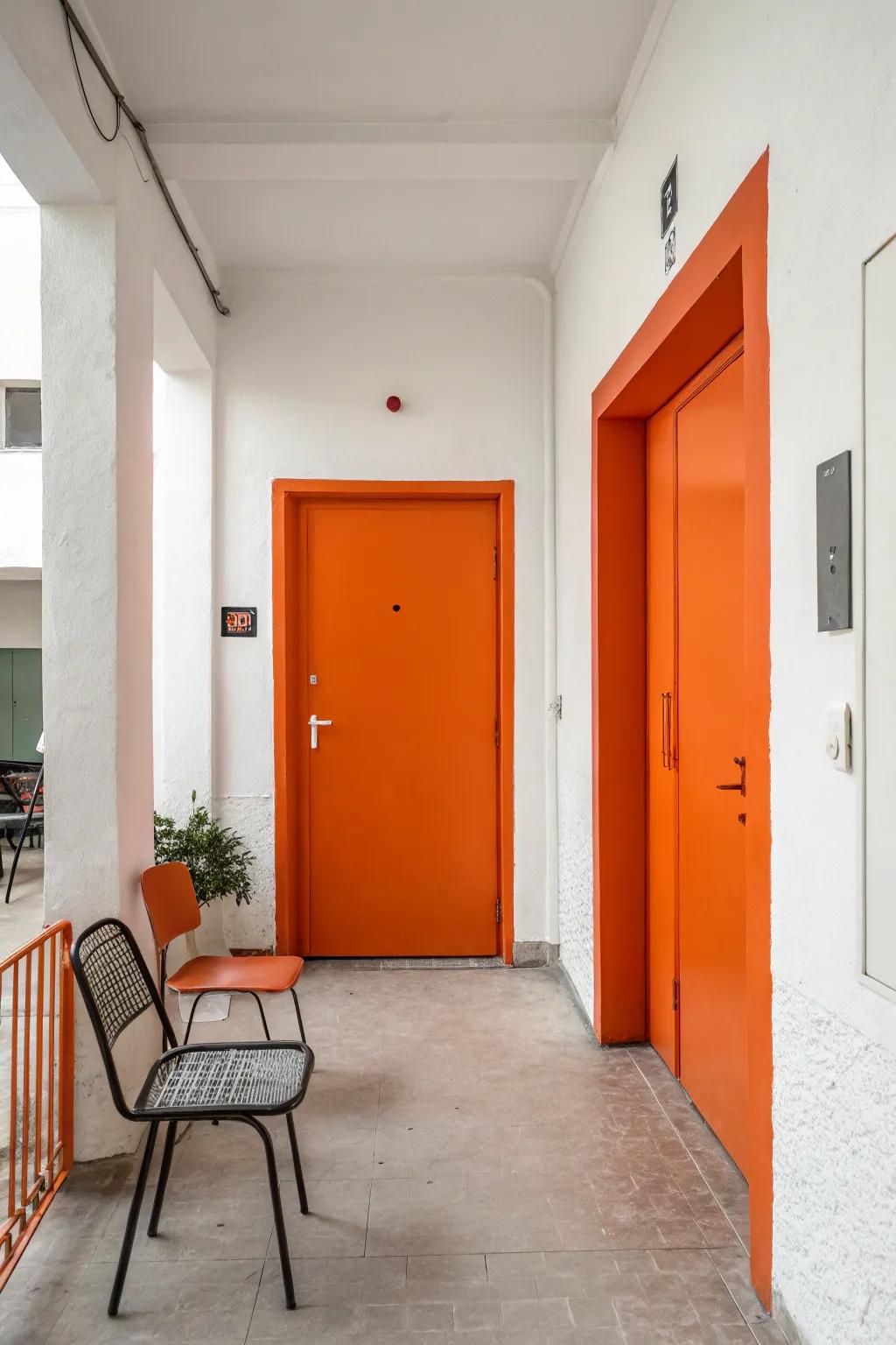 A bold tangerine door and ivory walls create a welcoming entryway.