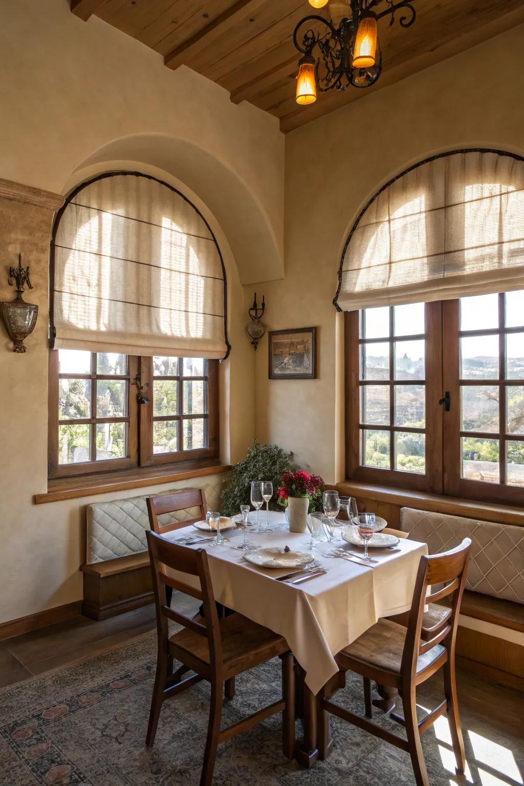 Intimate dining room with Roman shades on arched windows.