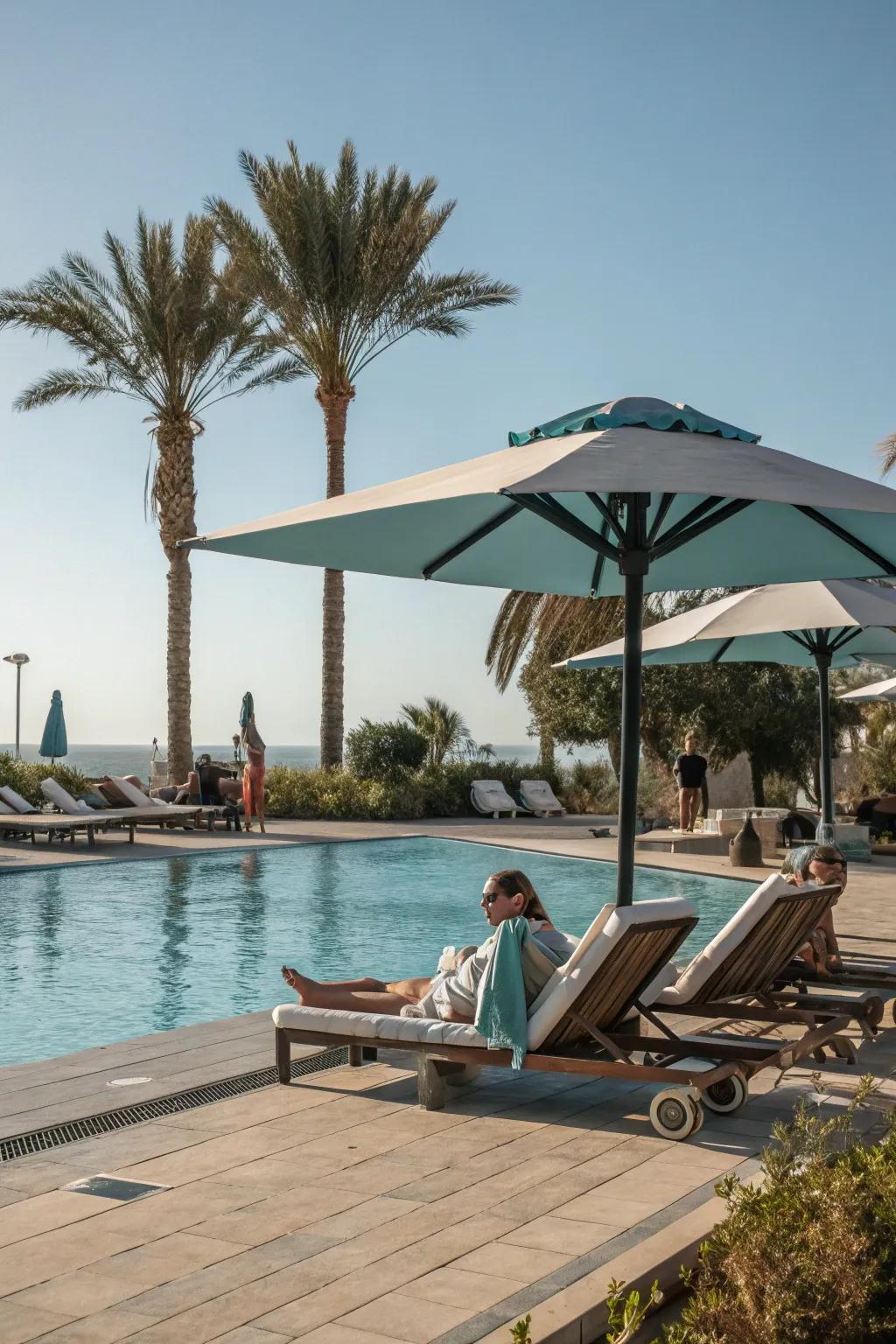 An invigorating poolside relaxation spot with umbrella shade.