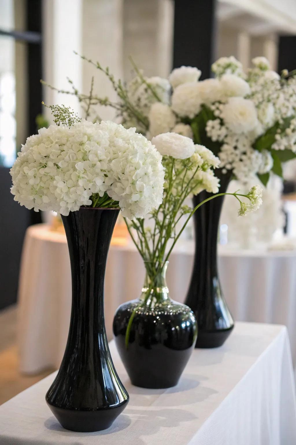 Elegant white flowers coupled with charcoal vases.