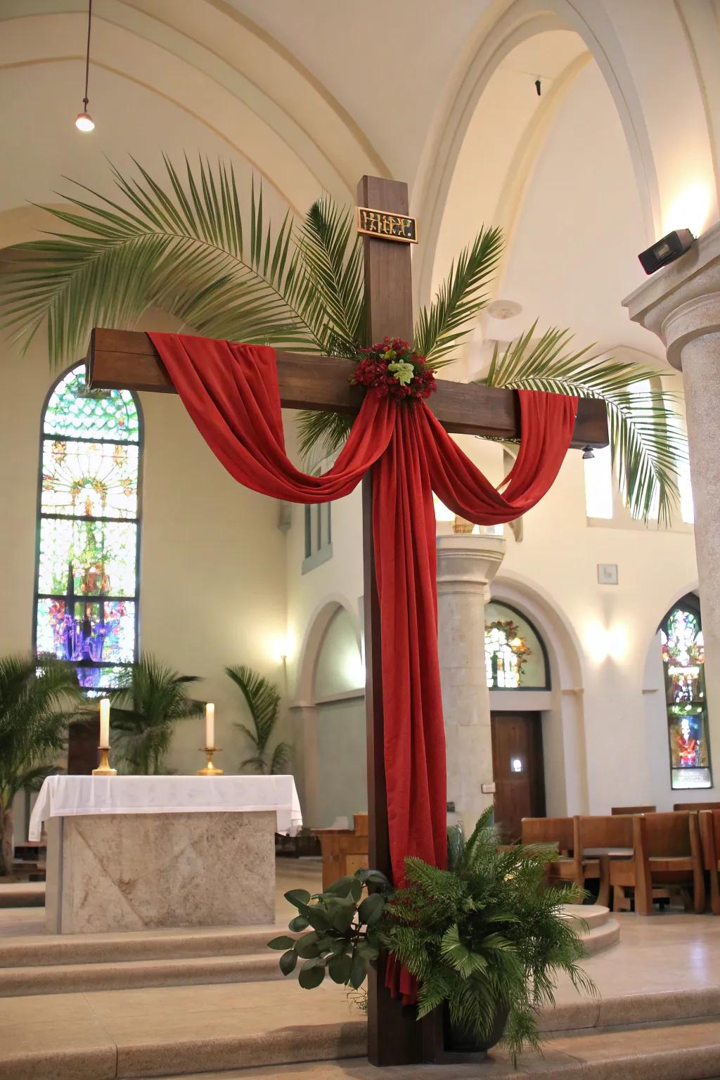 A cross decorated with scarlet fabric and palms, symbolizing Palm Sunday.