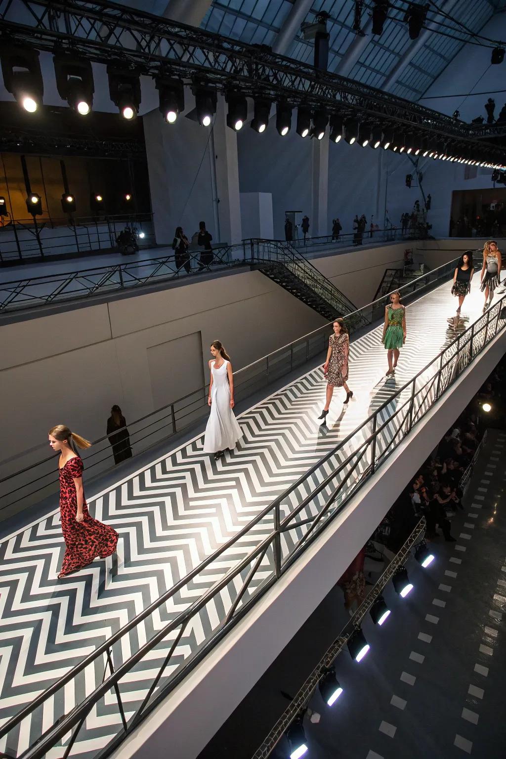An elevated zigzag runway offers a unique perspective for fashion show attendees.