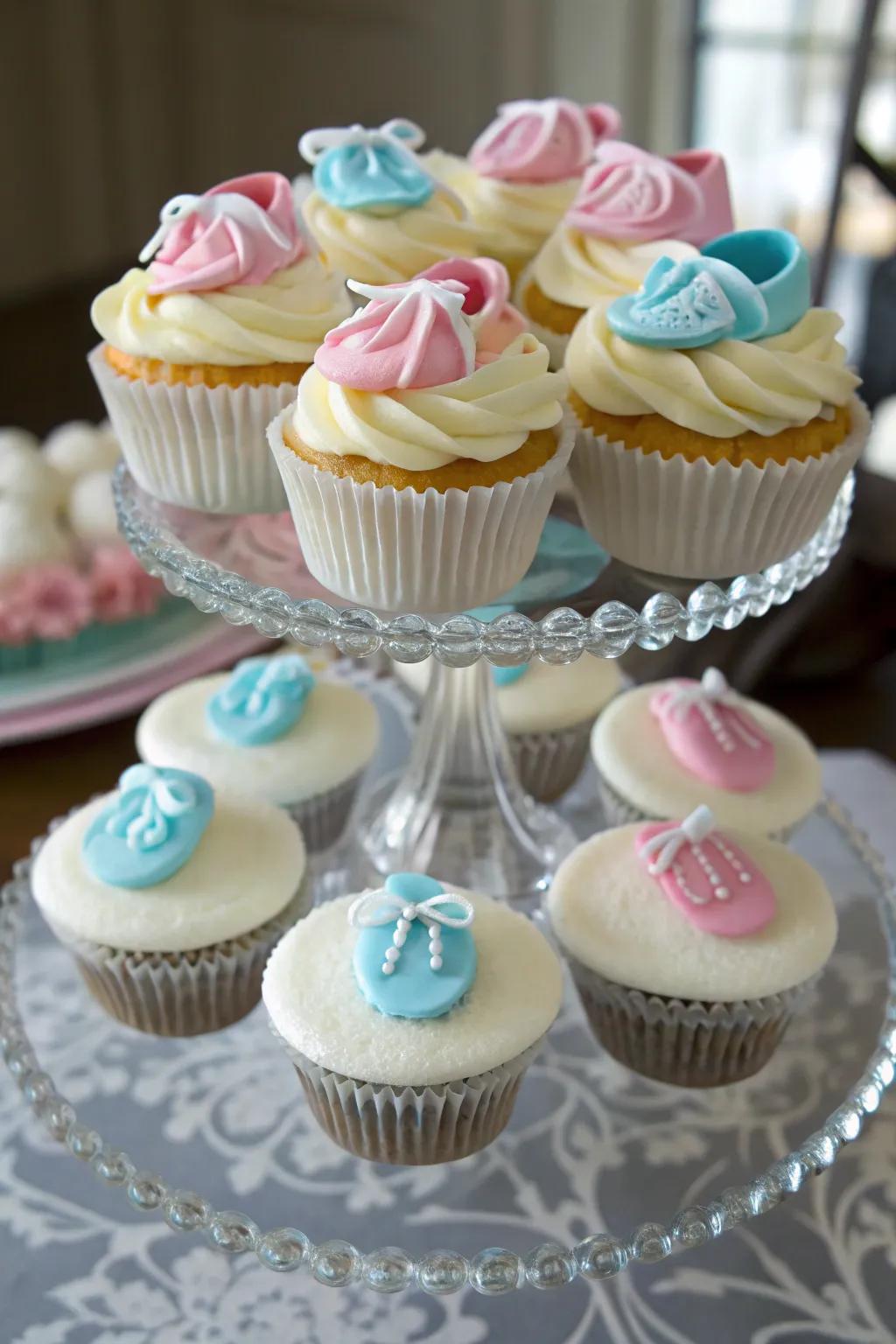 Charming cupcakes topped with baby booties, adding a whimsical flair.