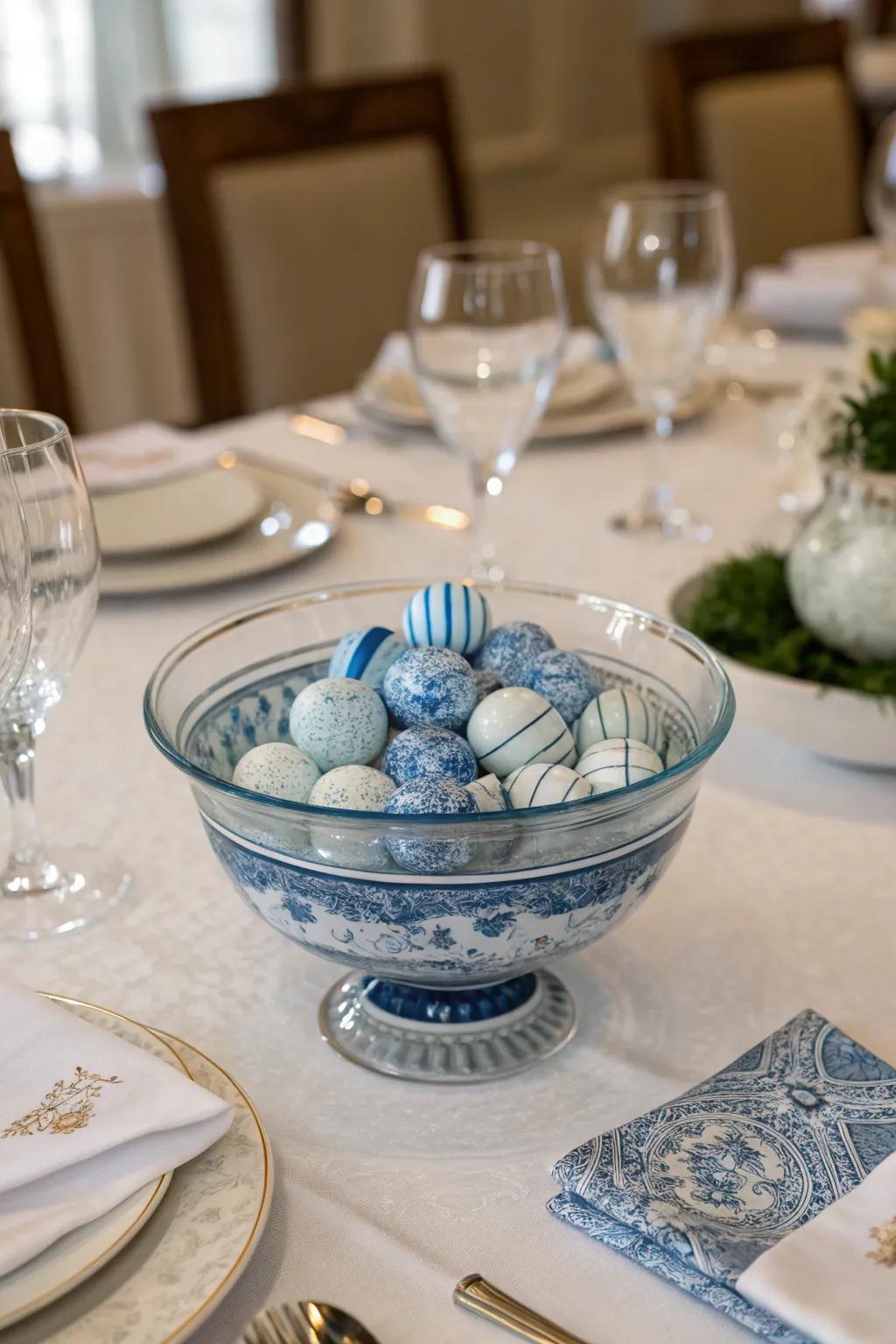 A glass bowl filled with elegant blue and white porcelain pieces