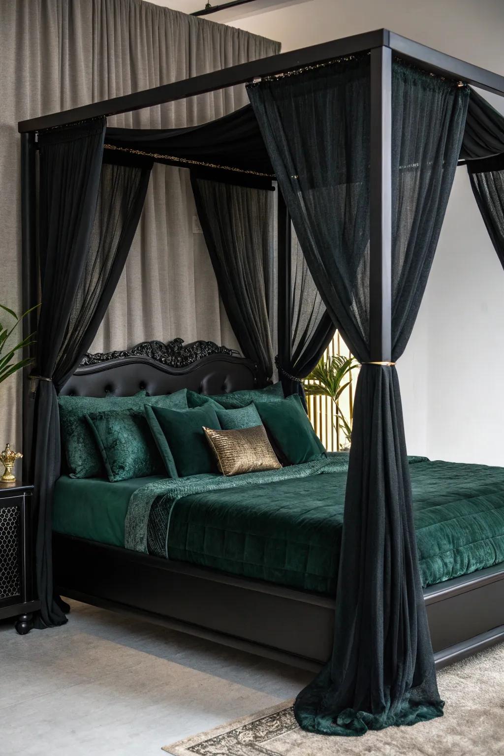 A black canopy bed with layers of luxurious green bedding.