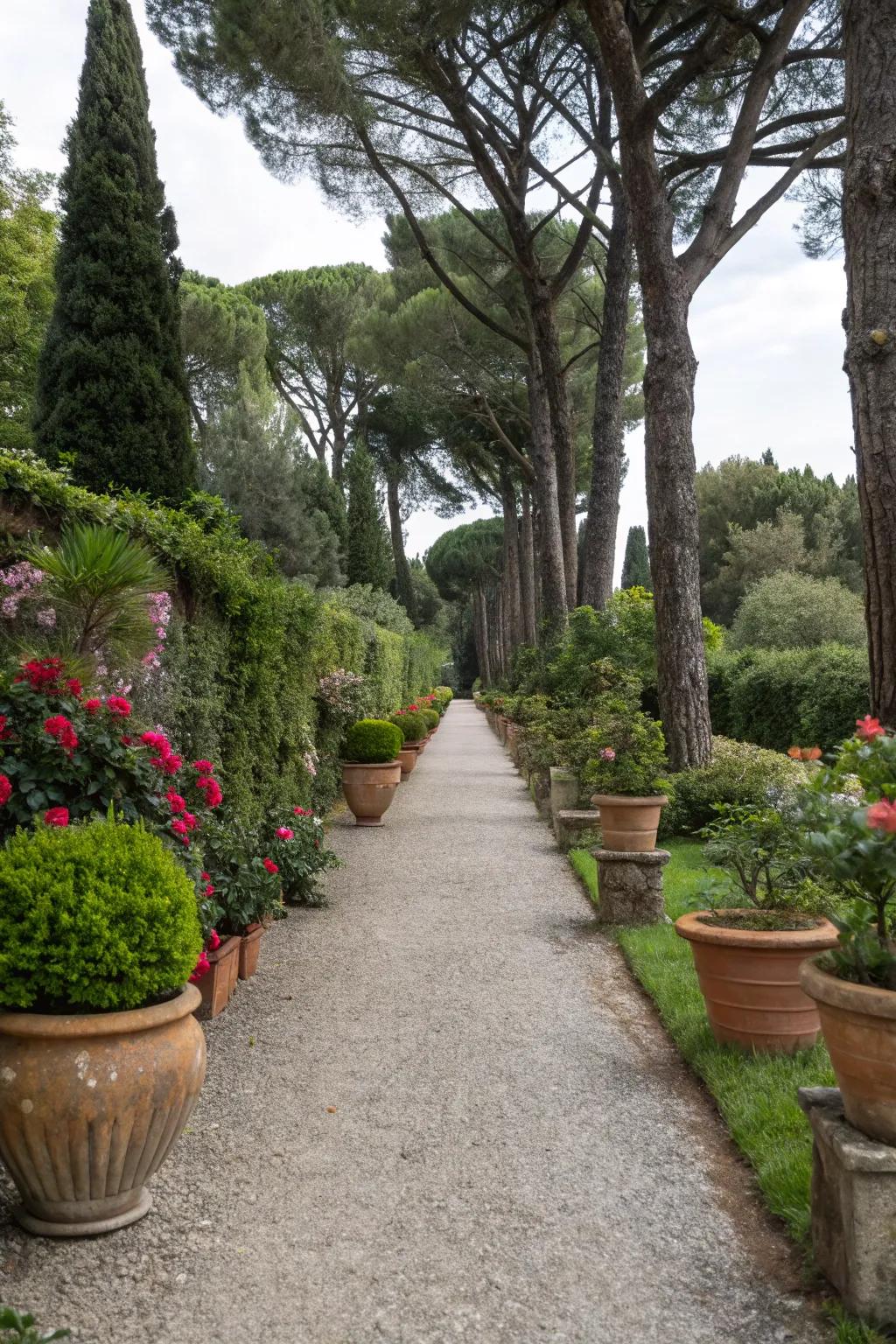 An elegant gravel path bordered by a variety of pots.
