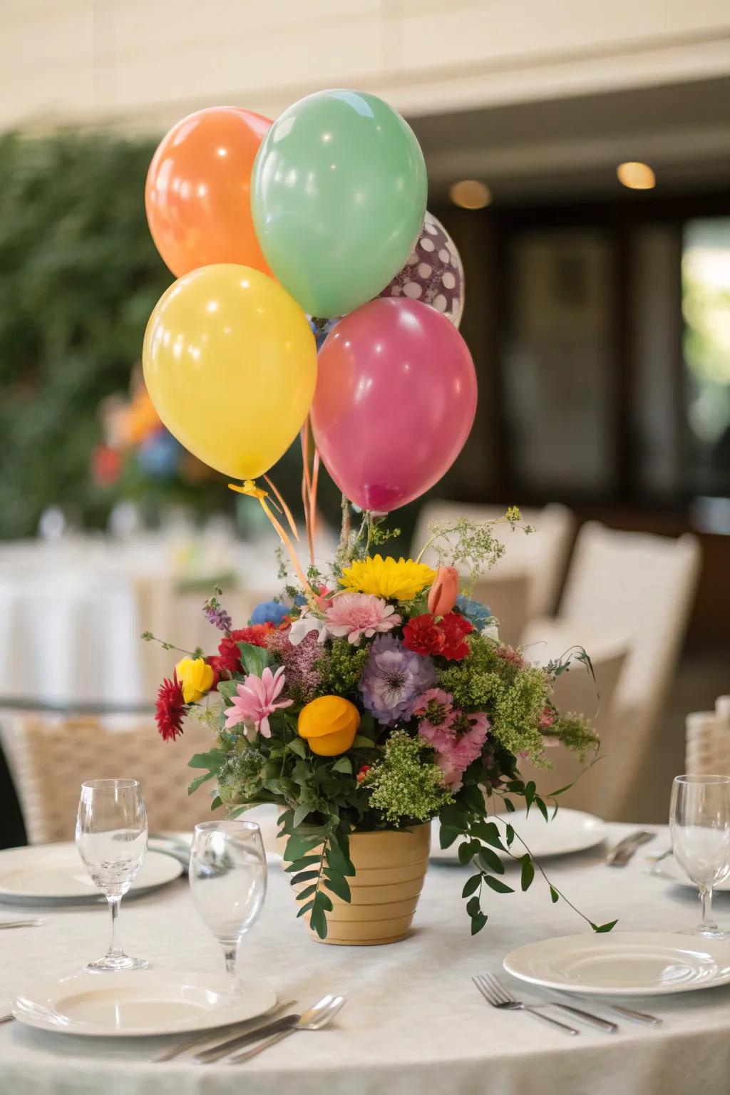 A vibrant table centerpiece blends balloons and flowers for a captivating display.