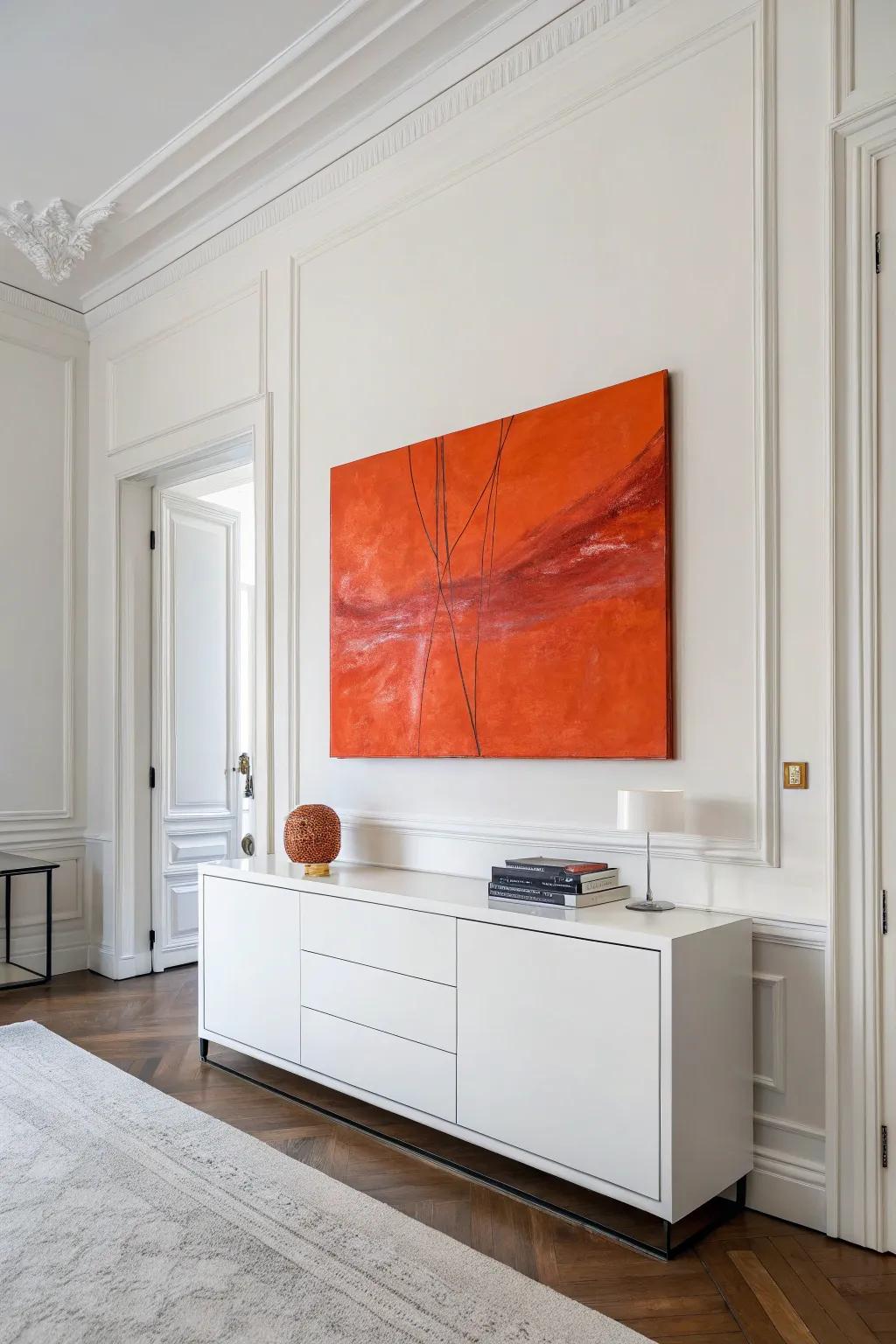 A striking piece of tangerine abstract art adds modern flair to a minimalist room.