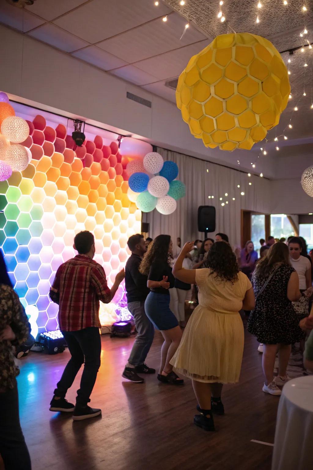 Establish the ambiance with a colorful hexagonal party backdrop.