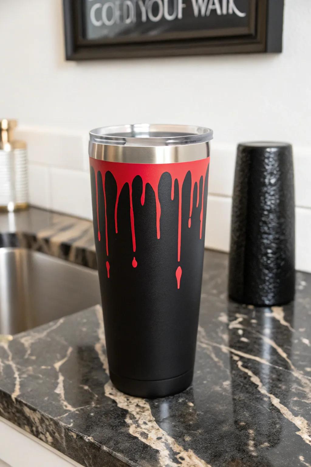 A bold red drip design that adds drama to a black tumbler.