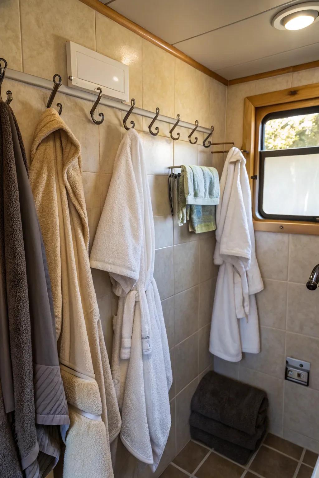 Hooks offering easy access to towels and robes in a camper bathroom.