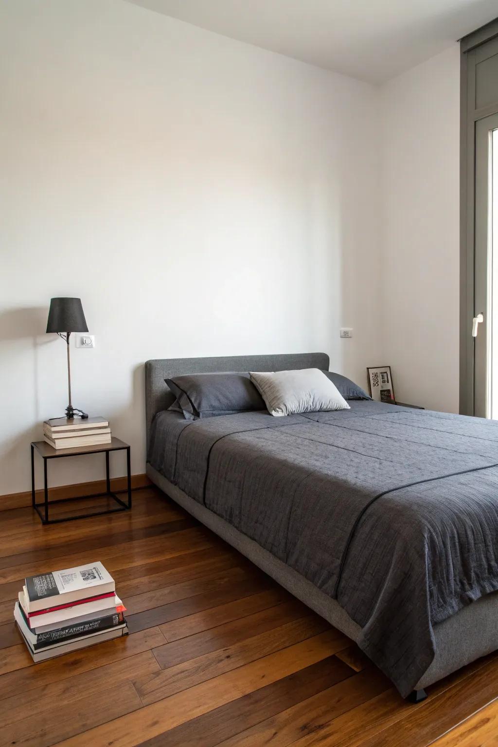 A tranquil refuge is created by minimalism and charcoal bedding.
