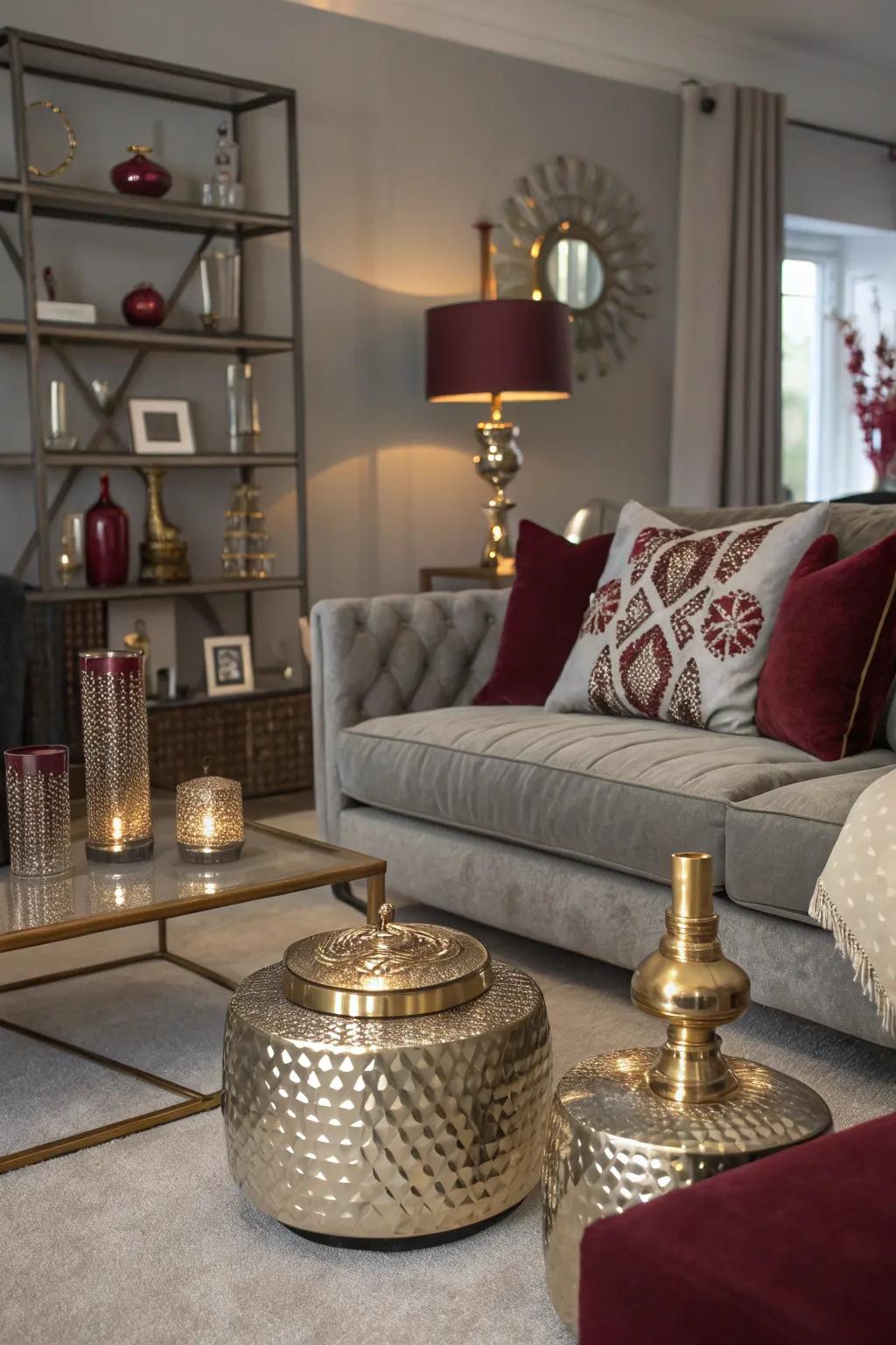 Living room with metallic accents and a grey and burgundy color scheme.