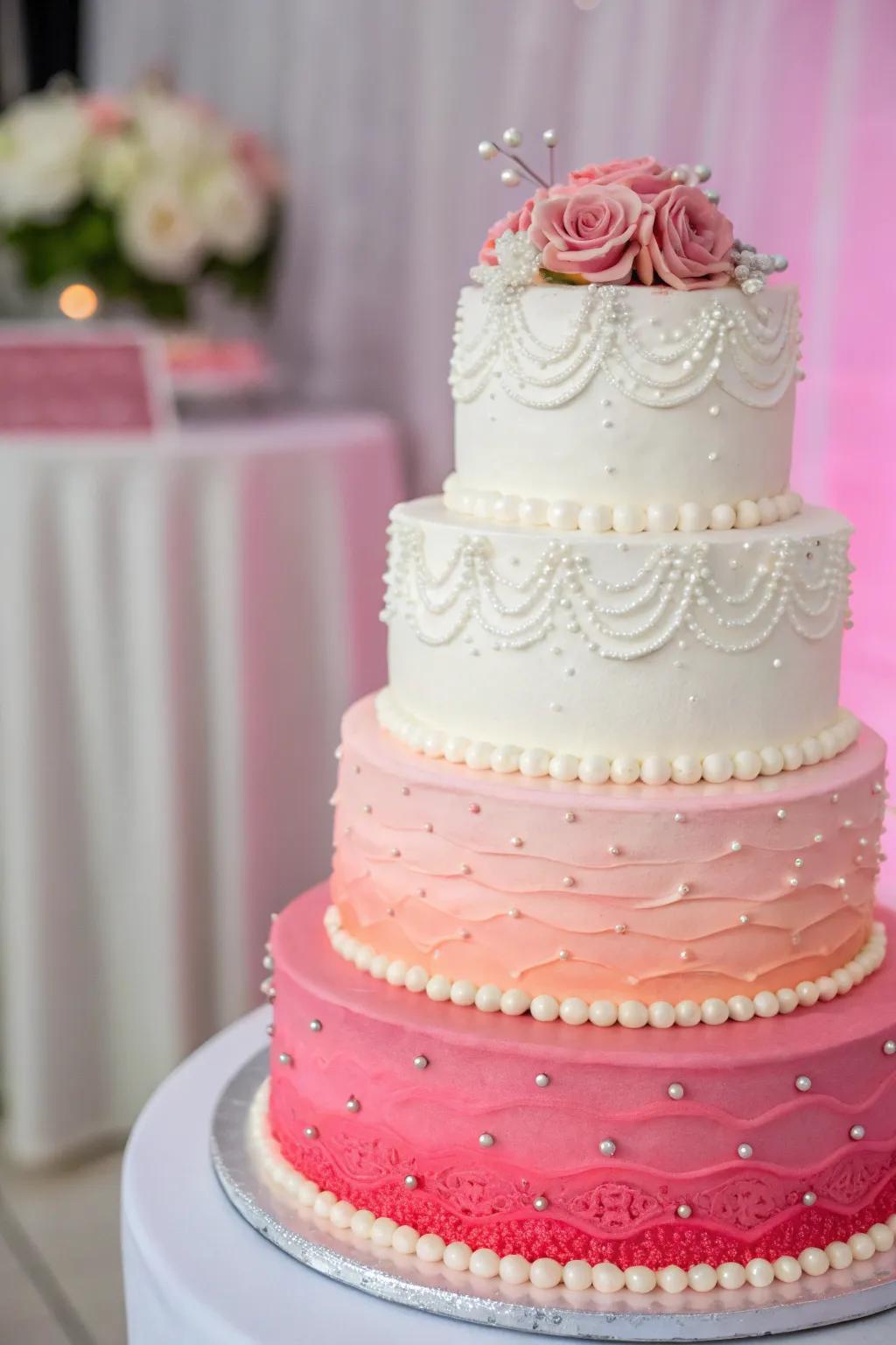 A graduated shade wedding cake transitioning from white to vibrant pink.
