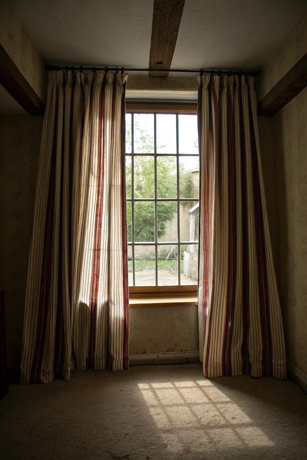 Striped drapes can visually enhance the room.