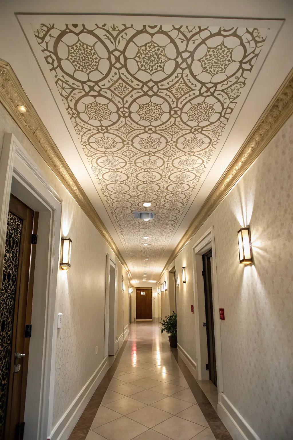 A hallway showcasing a tray ceiling adorned with a custom stenciled pattern.